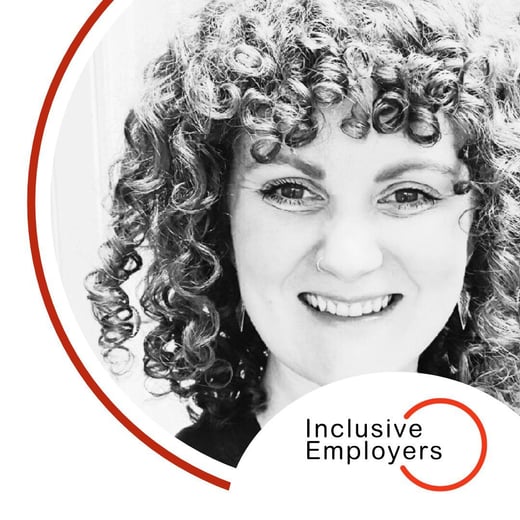 Image shows Kayla smiling at the camera. Kayle has shoulder length curly hair. The Inclusive Employers logo is in the bottom right corner.